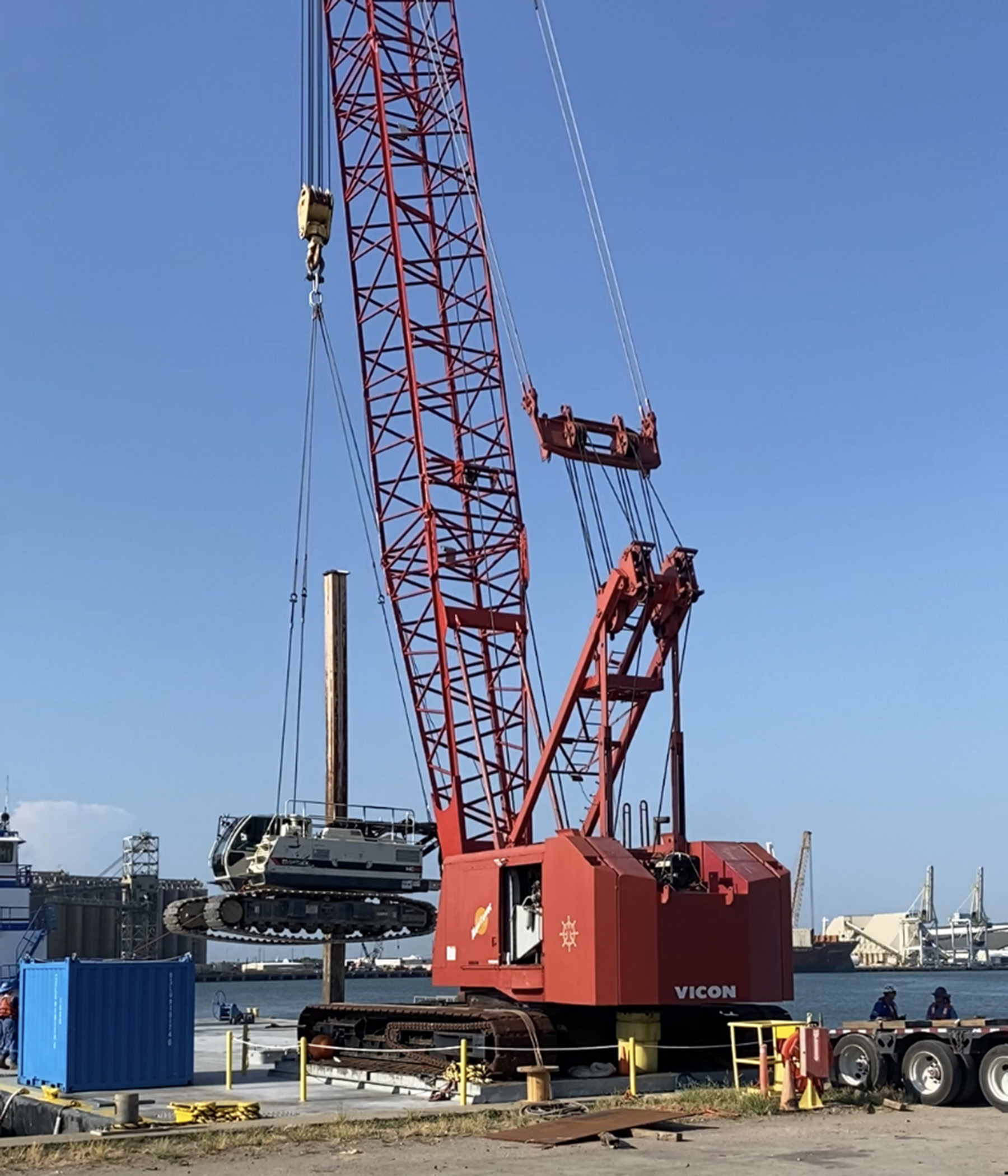 loading drill rig to barge for auger cast pile construction in Galveston, Texas